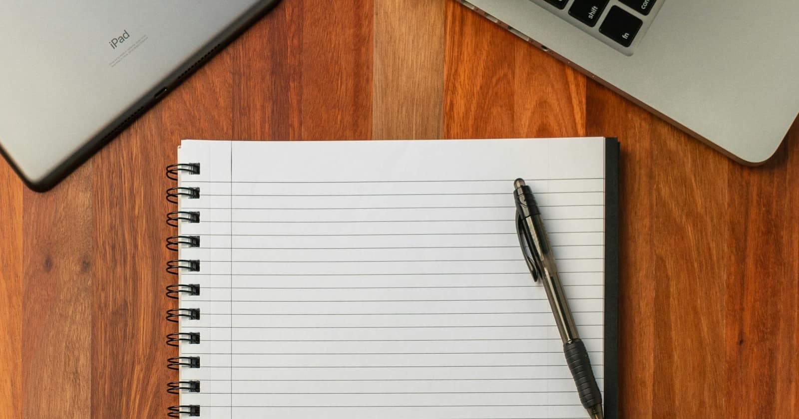 An open notebook with handwritten notes on a workspace