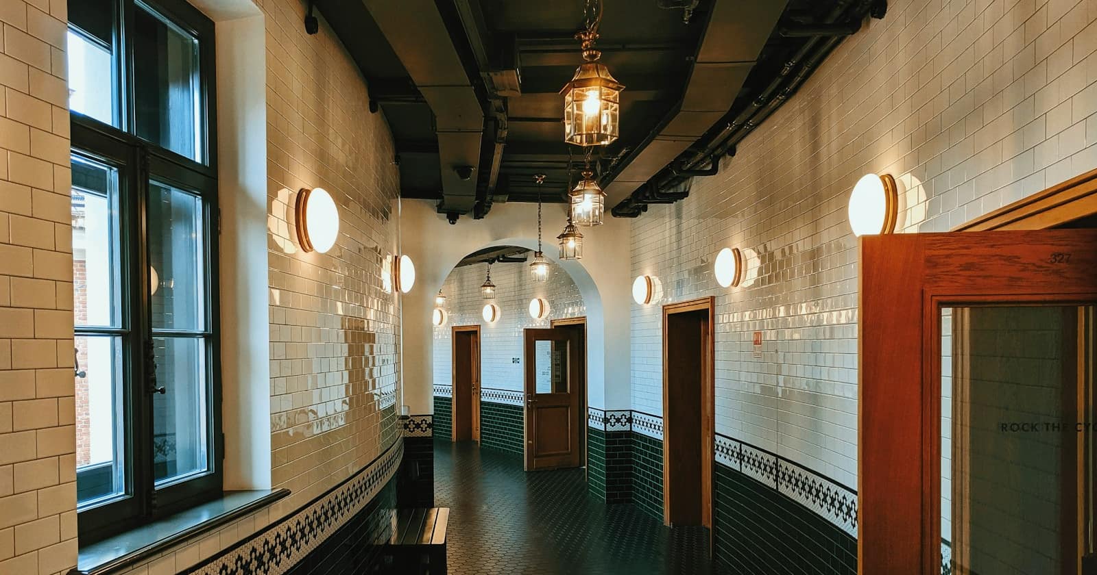 A corridor with many doors leading off it