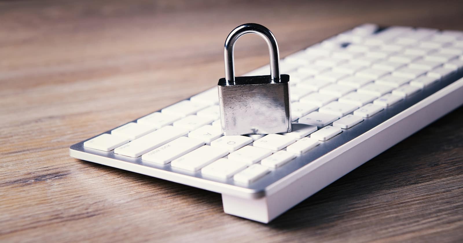 A key resting on a desk beside a laptop