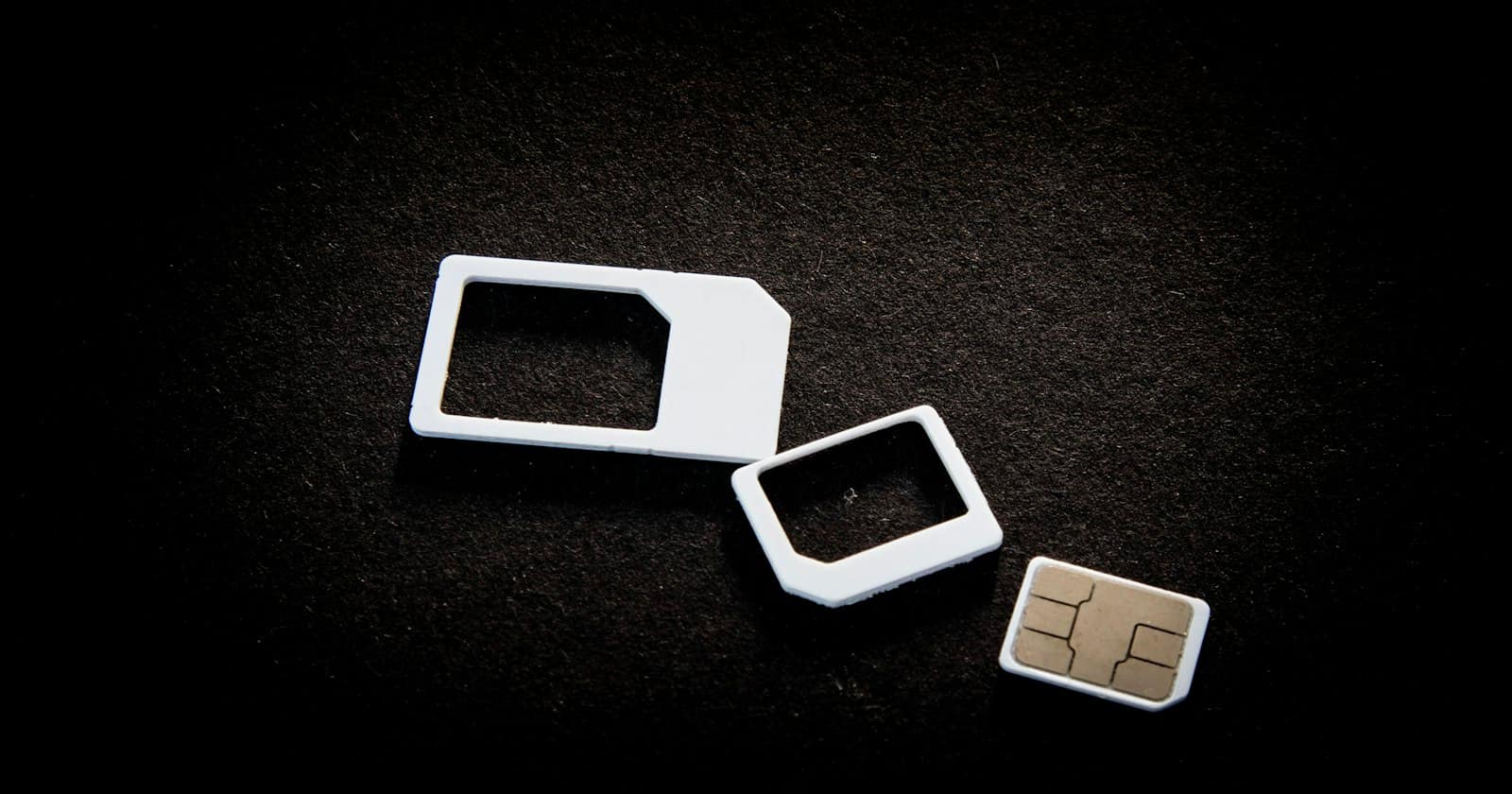 A SIM card beside a mobile phone