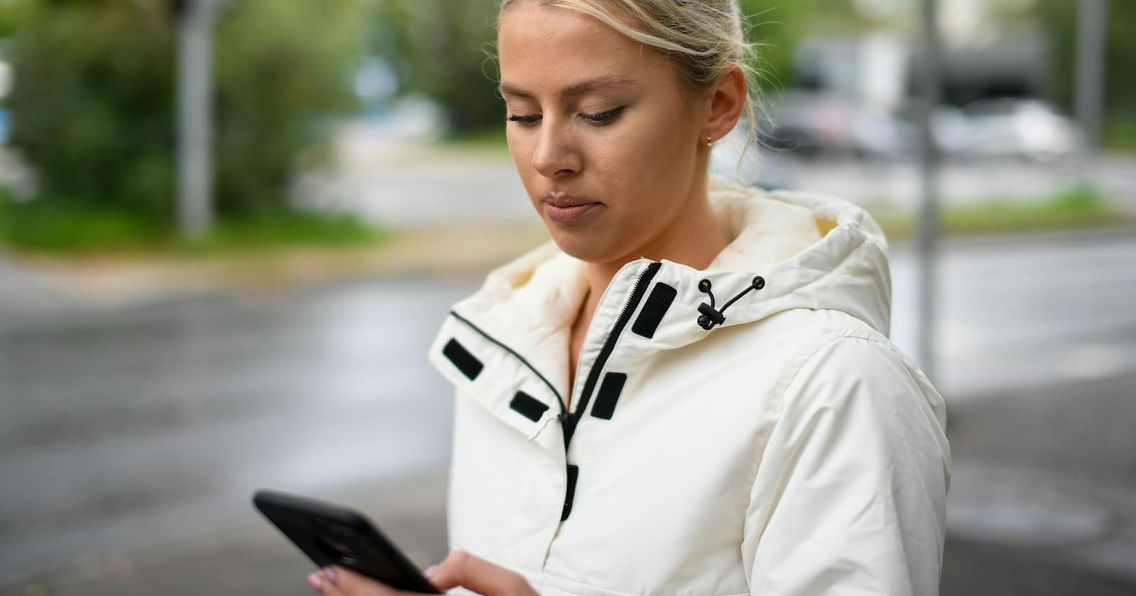 A smartphone showing a social media feed, with a chat conversation opening from an advertisement.