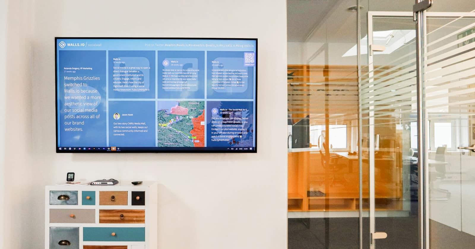 A comparison chart pinned to an office wall