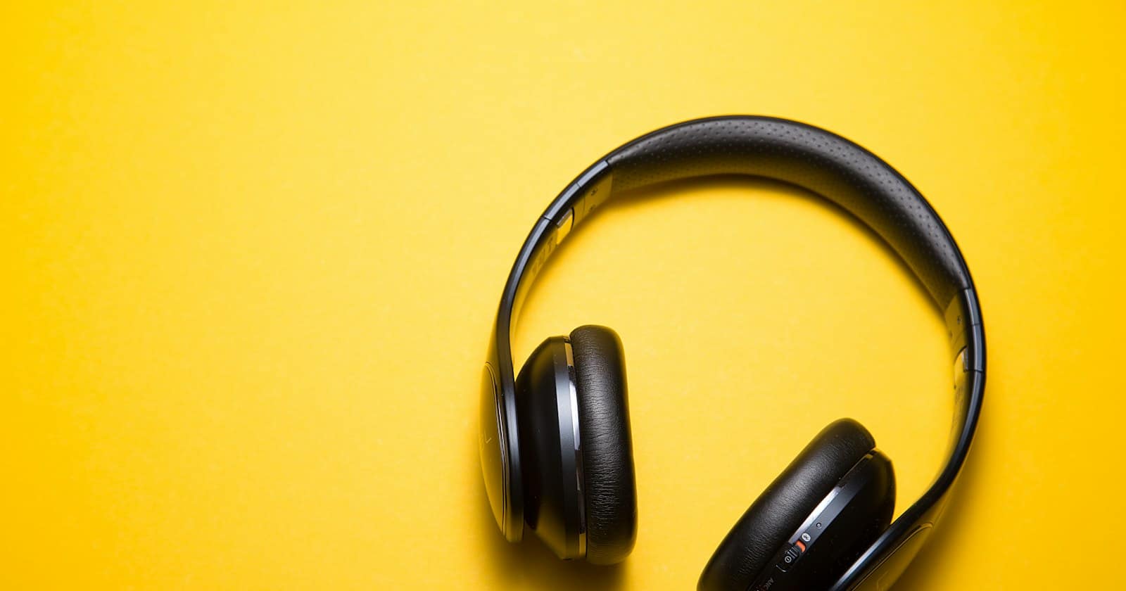Headphones resting beside audio equipment