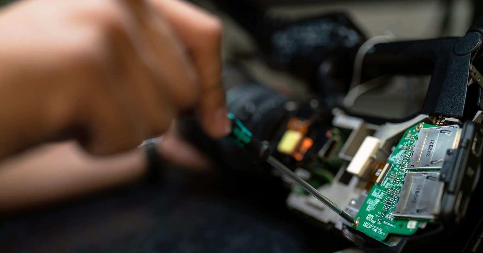 A technician photographing equipment during a repair