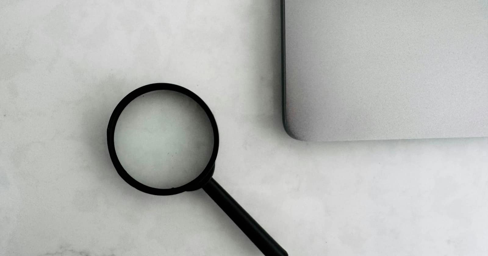 A magnifying glass resting on printed documents