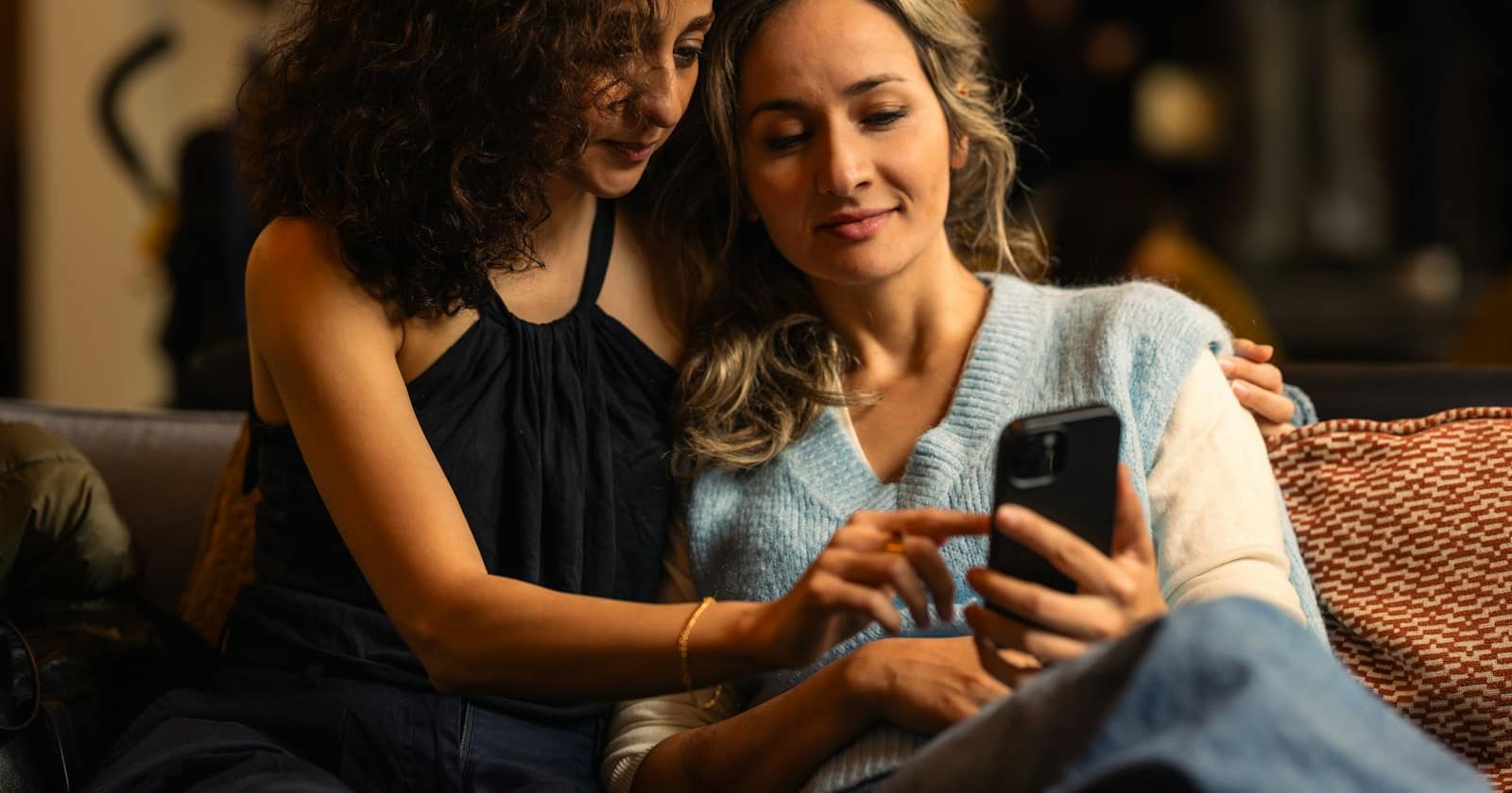 A customer holding a phone and forwarding a message to a friend in a WhatsApp chat