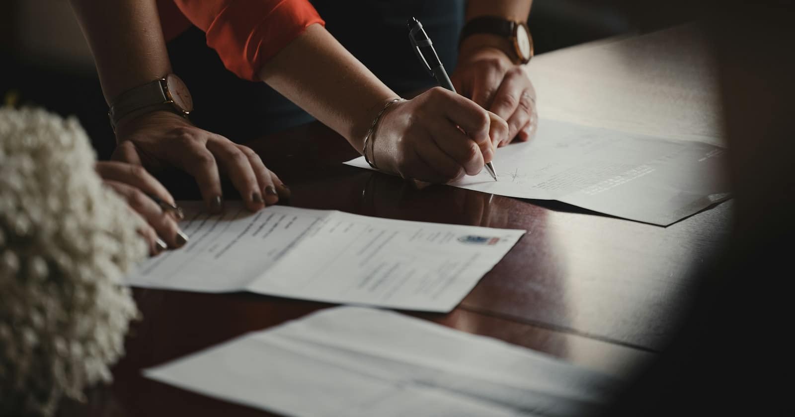 A contract being signed on a desk