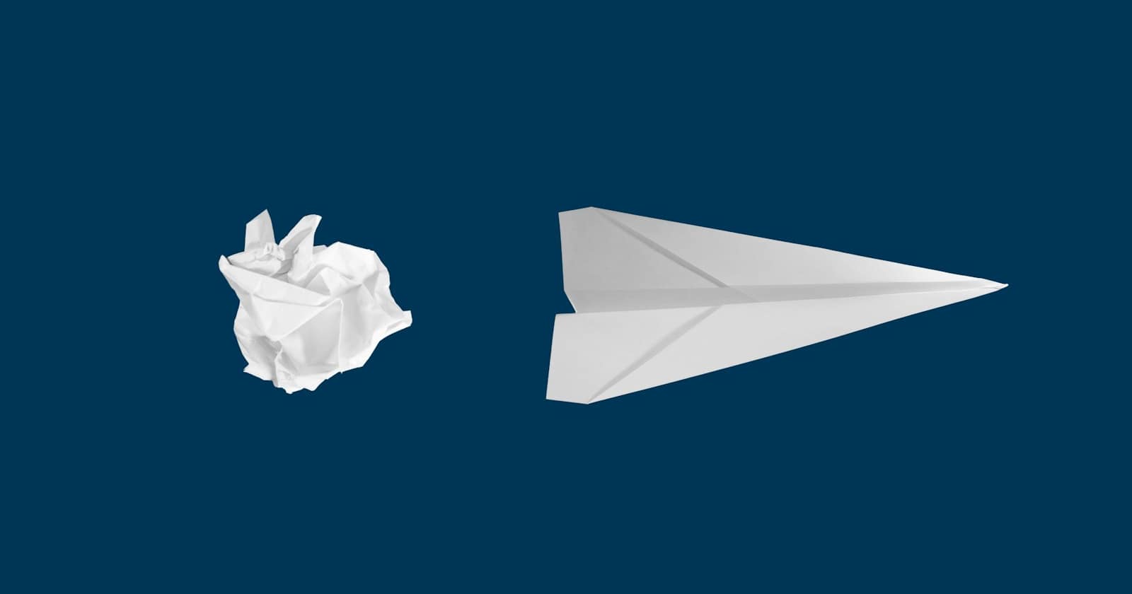 A paper plane against a plain blue background