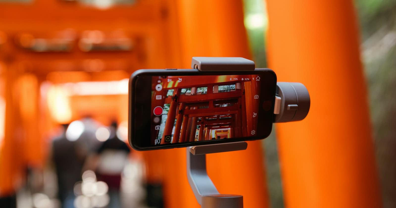 A smartphone on a small tripod filming a short clip