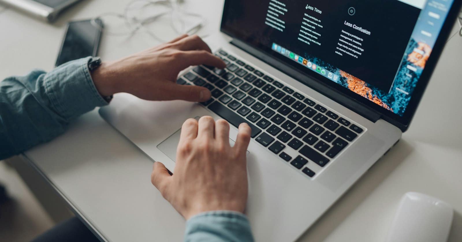 A laptop showing a company website with a chat button in the corner, next to a phone with an open WhatsApp conversation.
