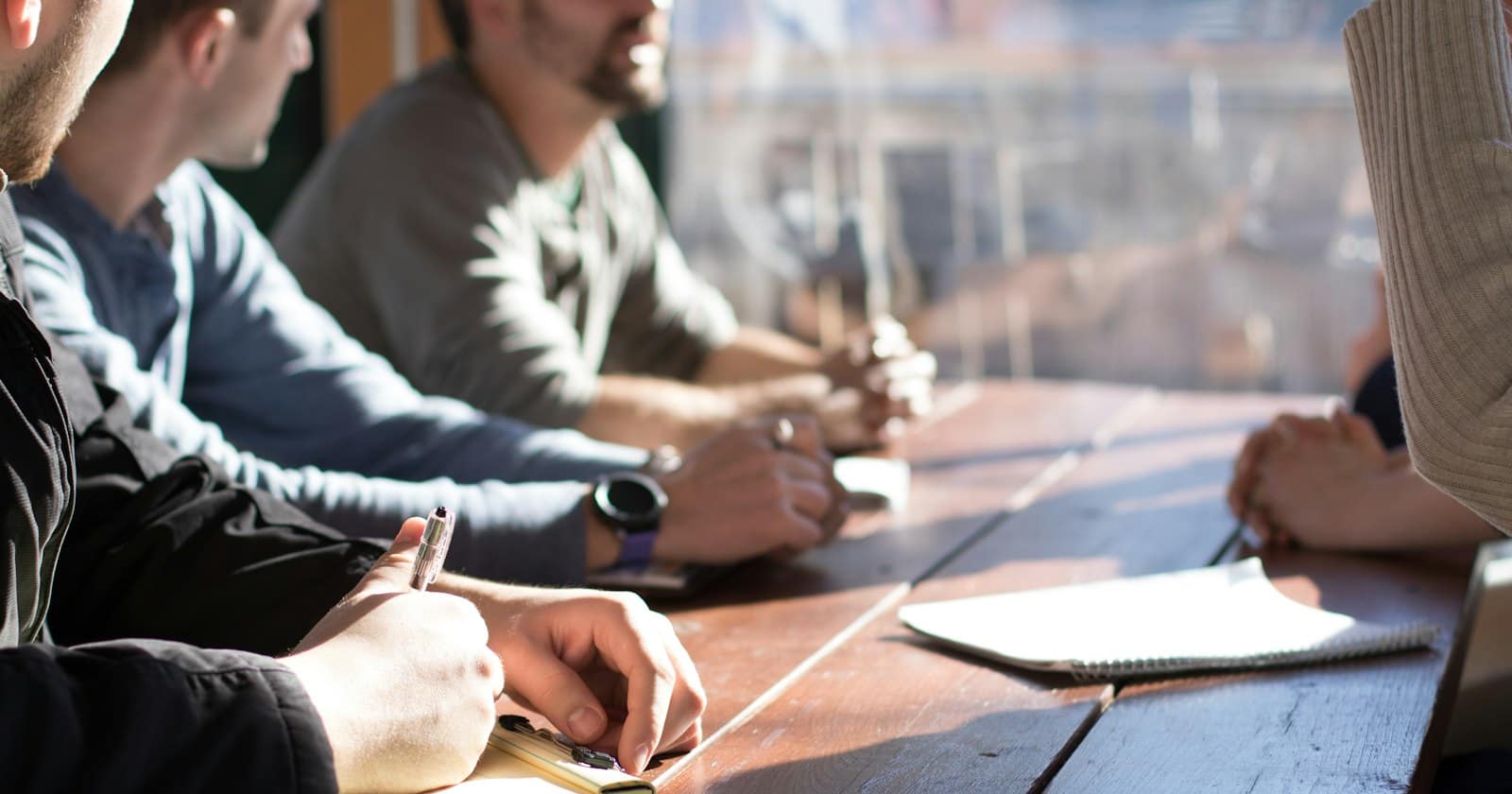 A small team reviewing work together around a table