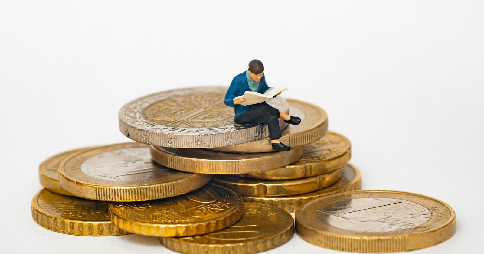 Stacked coins beside a notebook